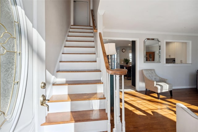 stairs featuring wood-type flooring and ornamental molding