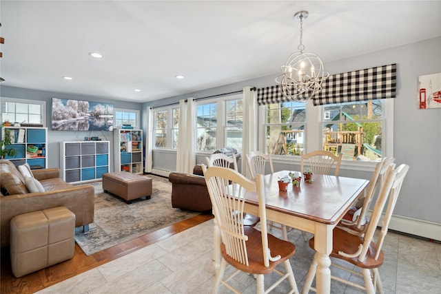 dining area featuring an inviting chandelier and light hardwood / wood-style flooring