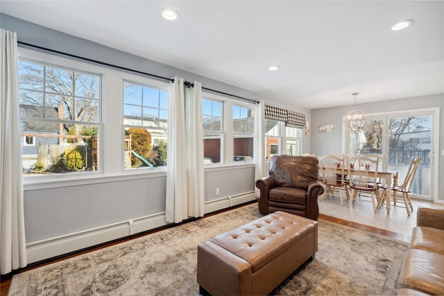 interior space with a baseboard radiator and an inviting chandelier