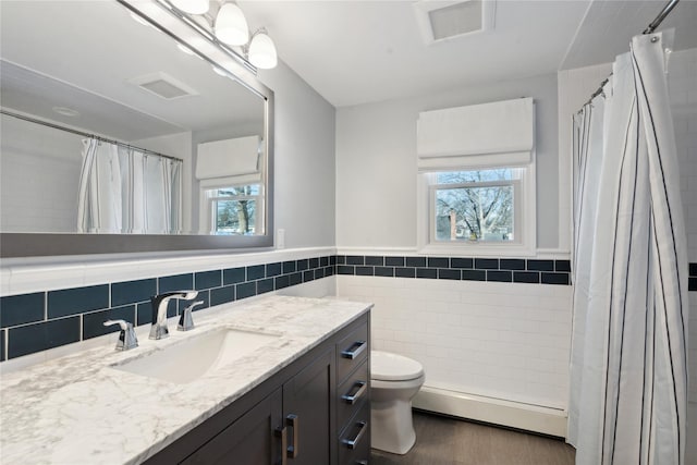 bathroom featuring a baseboard radiator, tile walls, vanity, toilet, and a shower with curtain