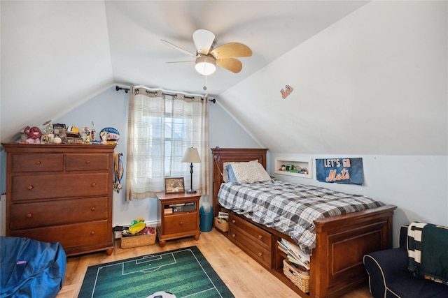 bedroom featuring ceiling fan, vaulted ceiling, and light hardwood / wood-style flooring