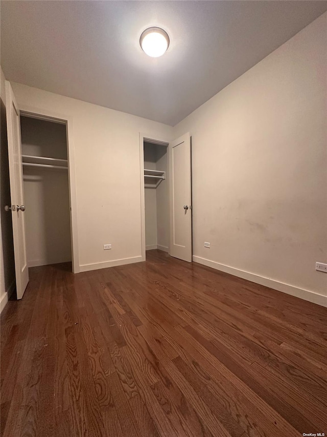 unfurnished bedroom featuring dark wood-type flooring