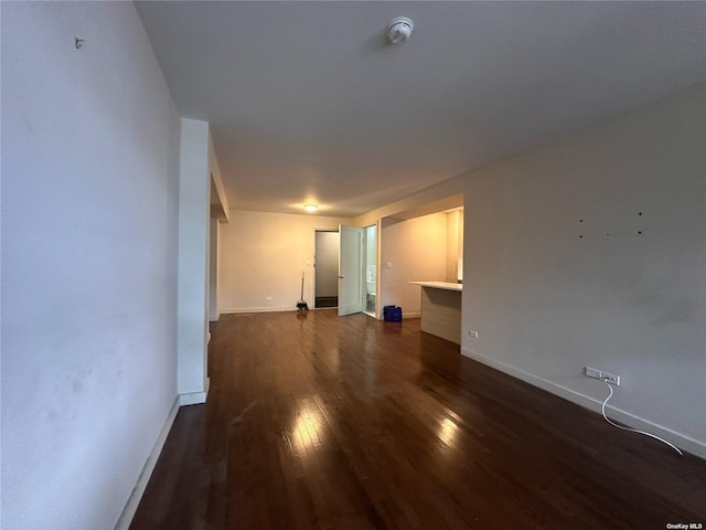 unfurnished room featuring dark hardwood / wood-style flooring