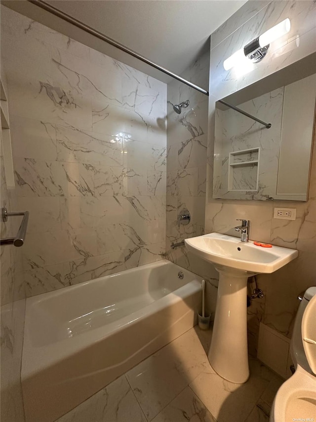 bathroom with tile walls, tiled shower / bath, and tasteful backsplash