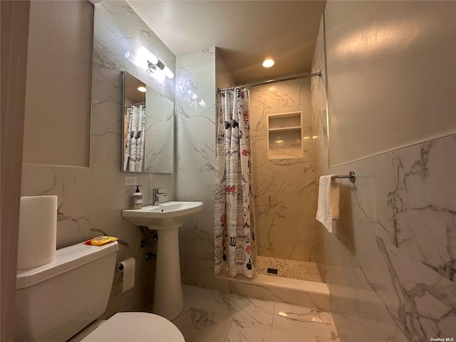 bathroom featuring toilet, walk in shower, and tile walls