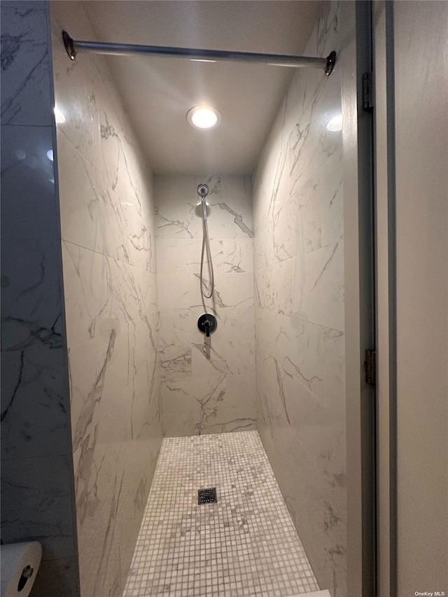 bathroom with a tile shower