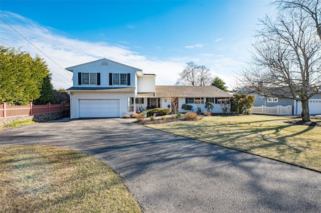 front of property featuring a garage, covered porch, and a front lawn