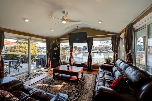 living room featuring wood-type flooring, lofted ceiling, and ceiling fan