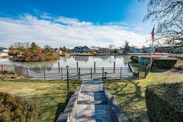 view of dock featuring a water view and a lawn