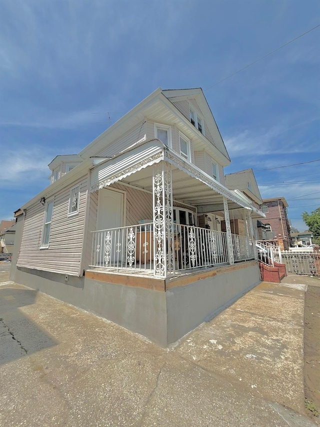 view of side of home featuring a porch