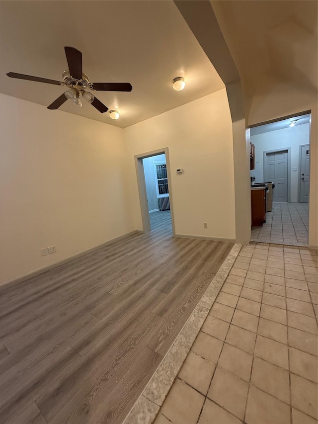 unfurnished room with light hardwood / wood-style flooring and ceiling fan