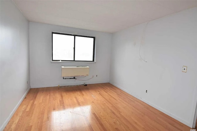 unfurnished room with light hardwood / wood-style floors