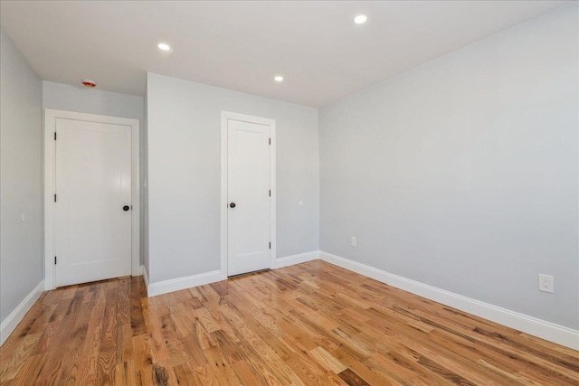 unfurnished room with light hardwood / wood-style floors