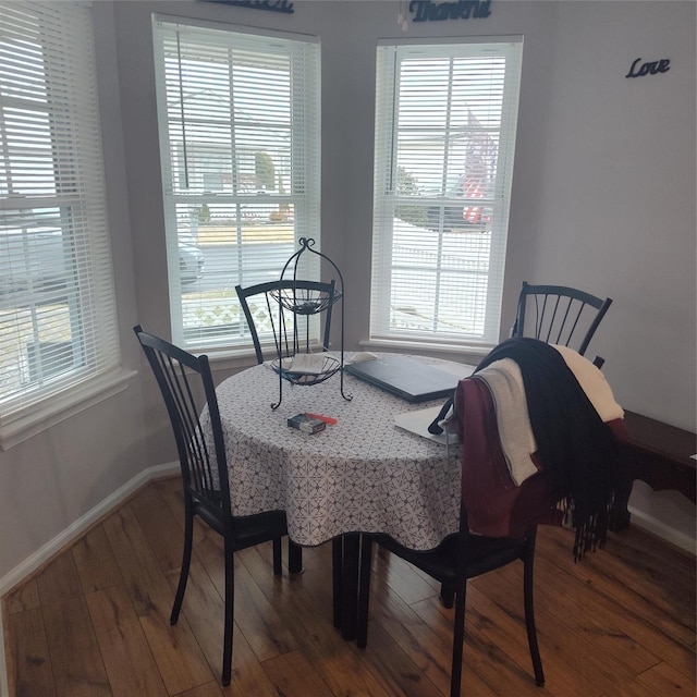 dining space with hardwood / wood-style floors