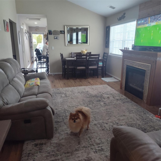 living room featuring hardwood / wood-style floors and lofted ceiling