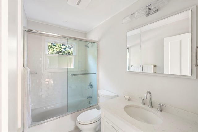 full bathroom featuring bath / shower combo with glass door, toilet, and vanity