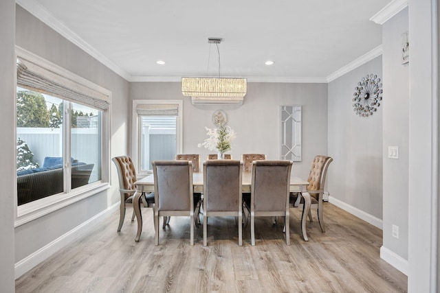 dining area with light hardwood / wood-style flooring and ornamental molding