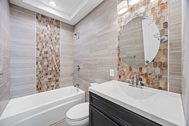 full bathroom featuring toilet, tile walls, bathtub / shower combination, and vanity