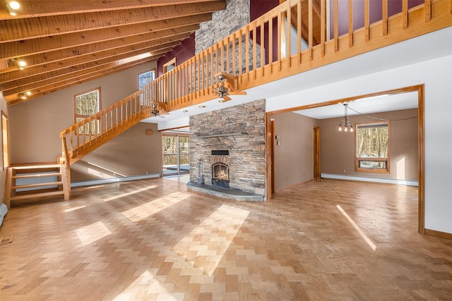 unfurnished living room with a high ceiling, a baseboard radiator, a fireplace, and parquet flooring