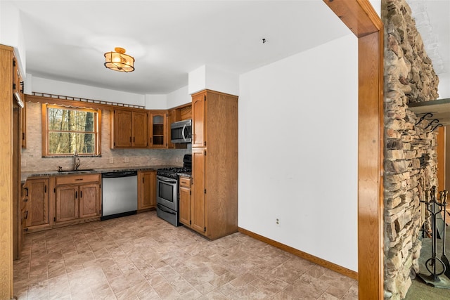 kitchen with sink, decorative backsplash, and appliances with stainless steel finishes