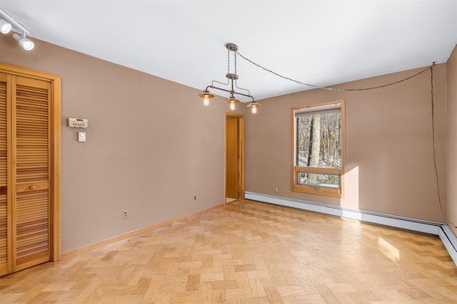 empty room featuring baseboard heating and light parquet floors