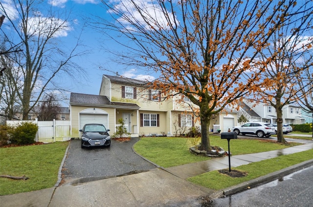 view of front of property featuring a garage and a front lawn