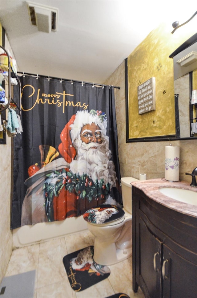 full bathroom featuring tile walls, vanity, shower / bath combination with curtain, and toilet