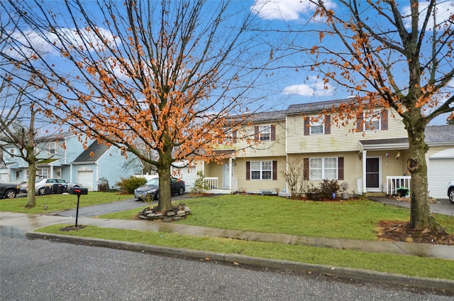 view of front of house with a garage and a front lawn