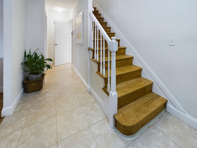 stairs featuring tile patterned flooring