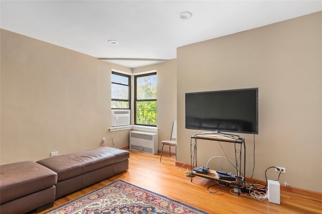 83-15 98th St Unit 6B, Woodhaven, NY 11421 - living room with radiator heating unit, wood finished floors, cooling unit, and baseboards