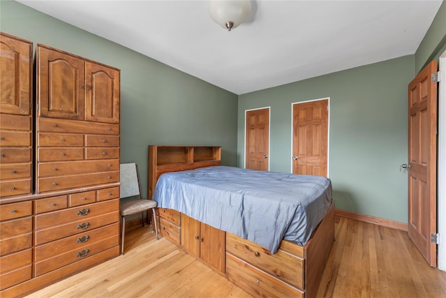 83-15 98th St Unit 6B, Woodhaven, NY 11421 - bedroom with light wood finished floors, two closets, and baseboards