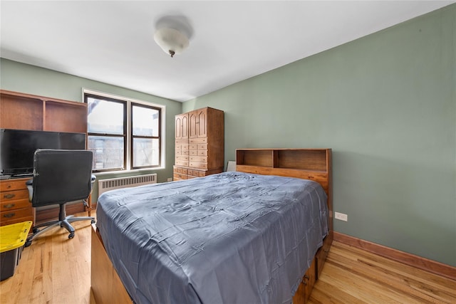 83-15 98th St Unit 6B, Woodhaven, NY 11421 - bedroom featuring radiator heating unit, light wood-type flooring, and baseboards