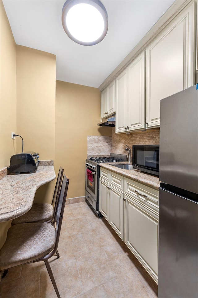 83-15 98th St Unit 6B, Woodhaven, NY 11421 - kitchen with stainless steel appliances, under cabinet range hood, decorative backsplash, baseboards, and light stone countertops