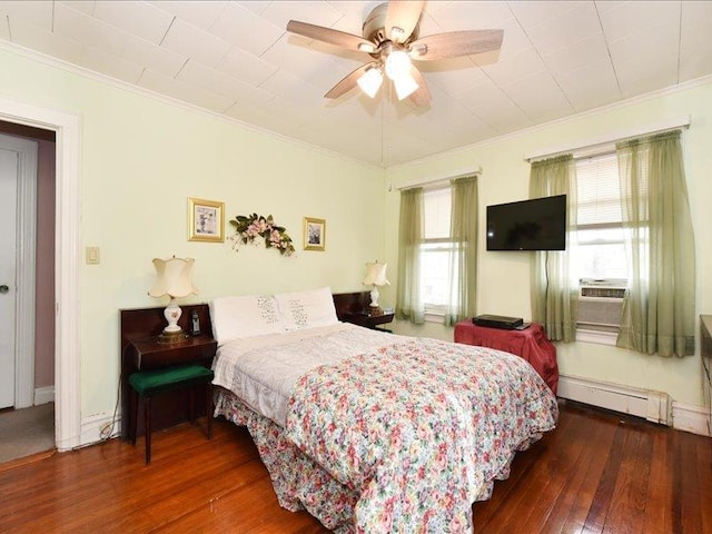 bedroom with hardwood / wood-style floors, crown molding, a baseboard heating unit, ceiling fan, and multiple windows