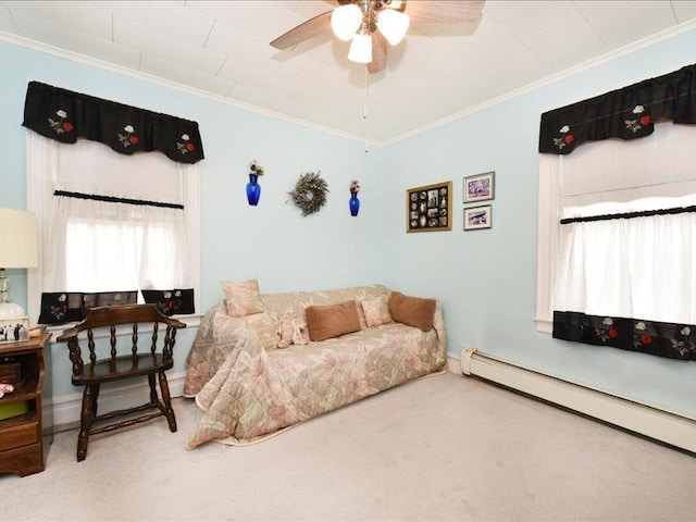 carpeted living room featuring ceiling fan, a baseboard heating unit, and crown molding