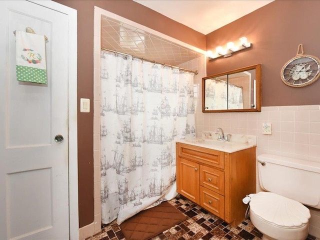 bathroom featuring tile walls, toilet, vanity, and a shower with curtain