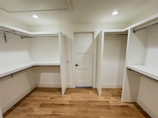 spacious closet featuring light hardwood / wood-style floors