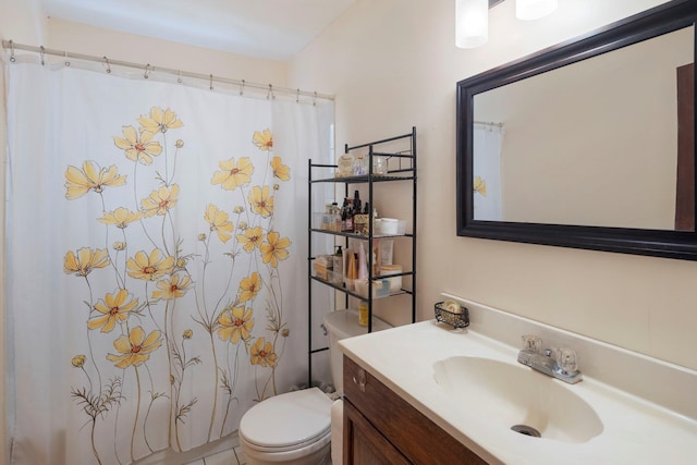 bathroom featuring walk in shower, vanity, and toilet