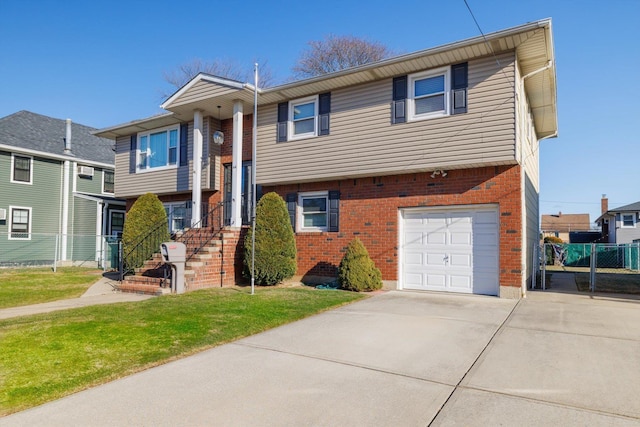 split foyer home with a front yard and a garage