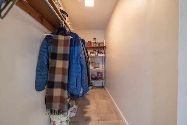 walk in closet with light tile patterned flooring