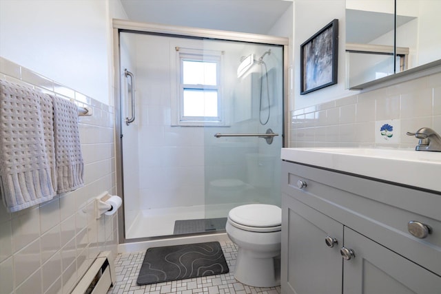 bathroom with an enclosed shower, toilet, tile patterned floors, and tile walls