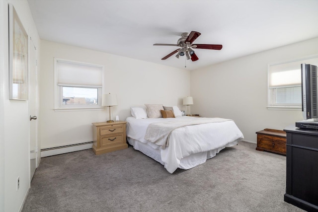 carpeted bedroom with ceiling fan and a baseboard radiator