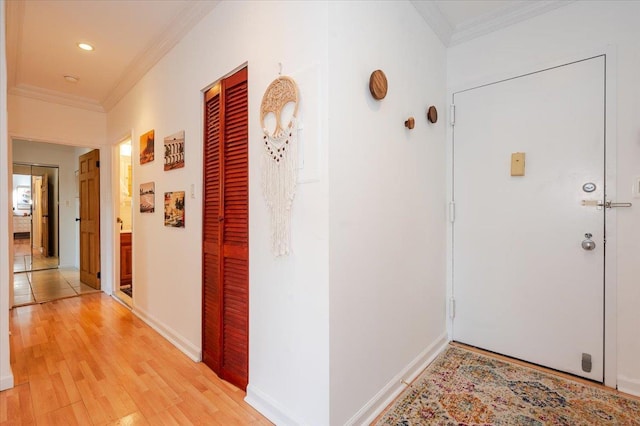 hallway featuring crown molding and light wood-type flooring