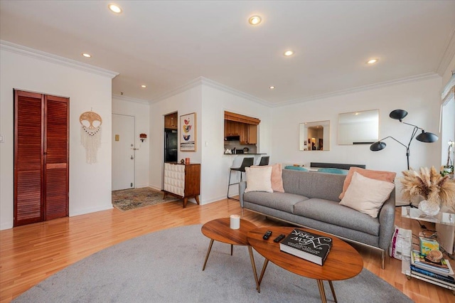 living room with light hardwood / wood-style flooring and ornamental molding