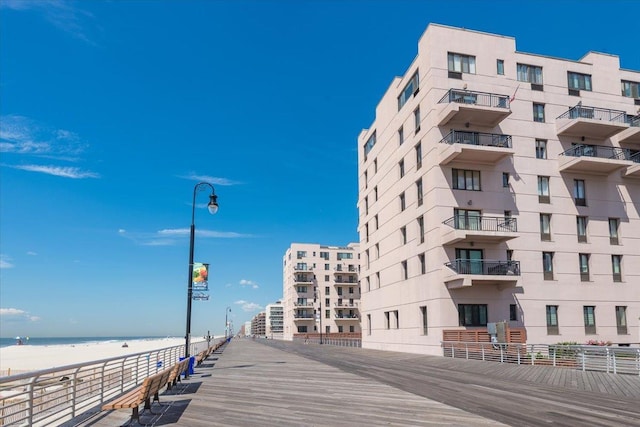 view of property featuring a water view and a beach view