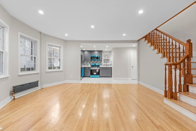 unfurnished living room featuring light hardwood / wood-style floors