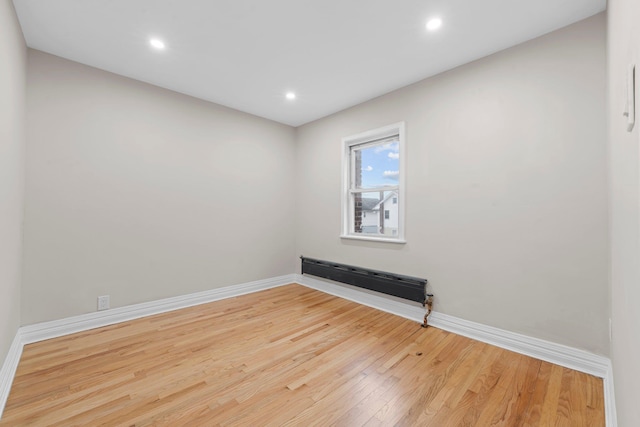 spare room with hardwood / wood-style floors