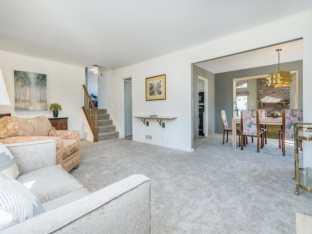 living room with carpet flooring and a chandelier