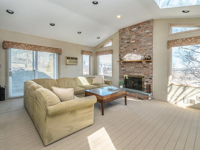 living room featuring a brick fireplace, vaulted ceiling, a wall unit AC, and a healthy amount of sunlight