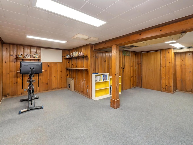 exercise area with light colored carpet and wood walls